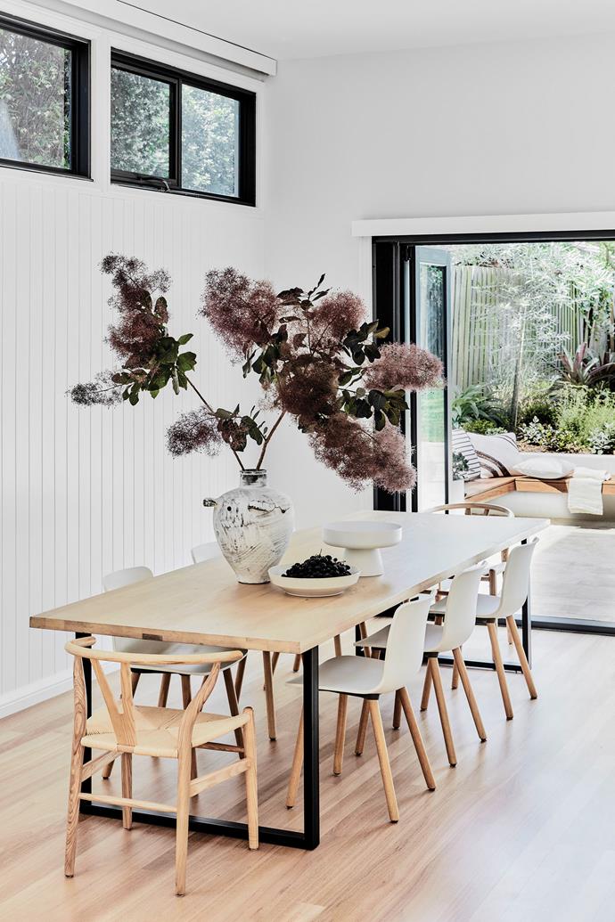 Windows on three sides make for wonderful all-day light. The Linea sleigh dining table is from [GlobeWest](https://www.globewest.com.au/|target="_blank"|rel="nofollow") and the chairs are a complementary mix of Vitra designs by Jasper Morrison and Wishbone chairs by Hans J Wegner. Walls, VJ panelling painted [Dulux](https://www.dulux.com.au/|target="_blank"|rel="nofollow") White Verdict Quarter. Vase, [Watertiger](https://watertiger.com.au/|target="_blank"|rel="nofollow").