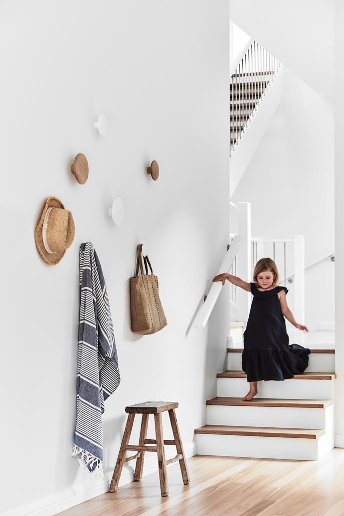Anais on her way downstairs. The refurbished timber flooring is stained a light oak colour and finished with matt polyurethane. Wall hooks, [Muuto](https://www.muuto.com/|target="_blank"|rel="nofollow"). Stool, [Few & Far](https://www.fewandfar.com.au/|target="_blank"|rel="nofollow"). Jute bag, [The Dharma Door](https://thedharmadoor.com.au/|target="_blank"|rel="nofollow").