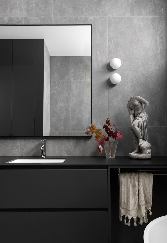 Rachel wanted the main bathroom to feel calm and luxurious, so she chose dark and moody Italian porcelain tiles, custom joinery by Wynn Joinery and stone from Stonelux. The headless vintage sculpture, from Rachel Donath, is a playful, final touch. And it's nice to know it's not watching you while you use the facilities.
