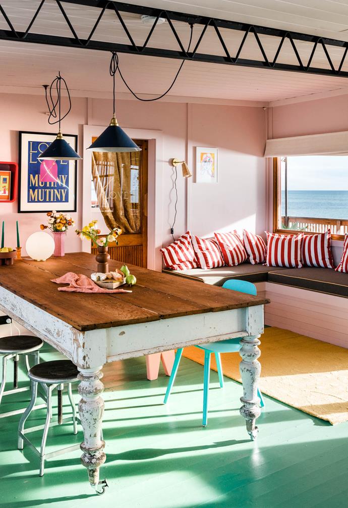 Splashes of coral pink, forest green and mustard breathe new life into the interiors of [this 1950s beach shack](https://www.homestolove.com.au/love-and-mutiny-airbnb-23638|target="_blank") just two hours north of Adelaide, whilst honouring the property's vintage charm. "We started with colours. We always wanted to do a green floor, and the colours inside reflect the sunset colours," the owner Sarah Read explains of the colour choices.