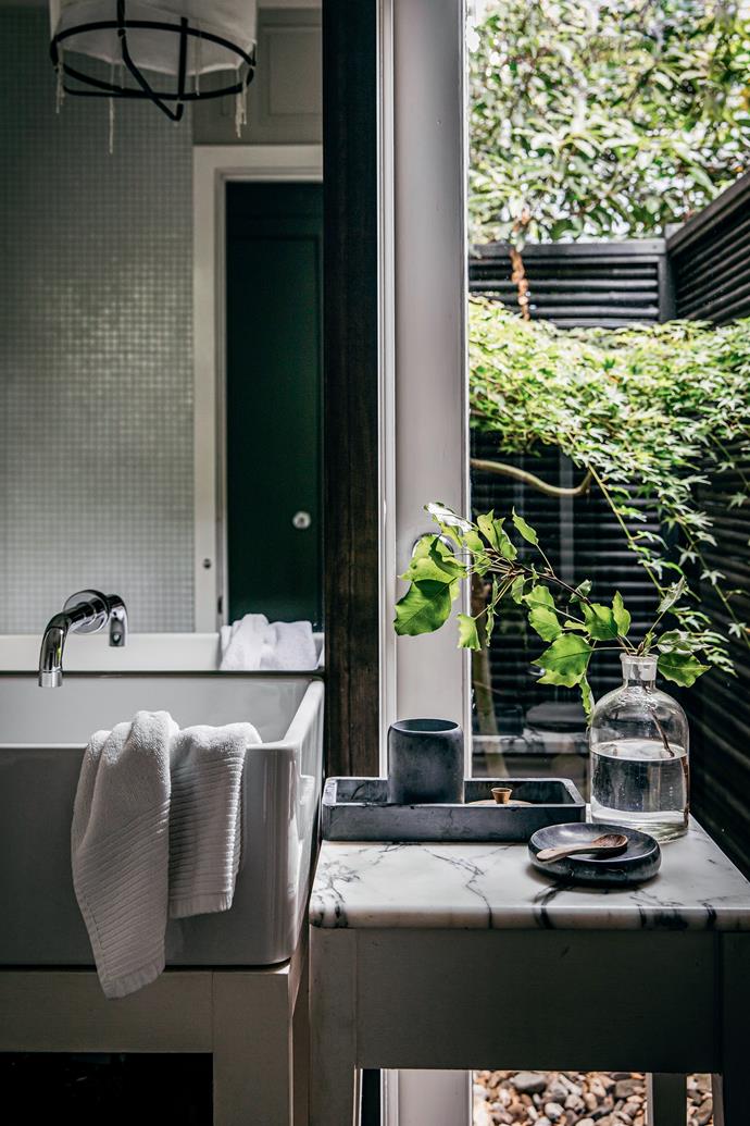 The main bathroom has a Zen feel with its view of a [Japanese garden](https://www.homestolove.com.au/japanese-style-garden-17961|target="_blank") and simple white palette.