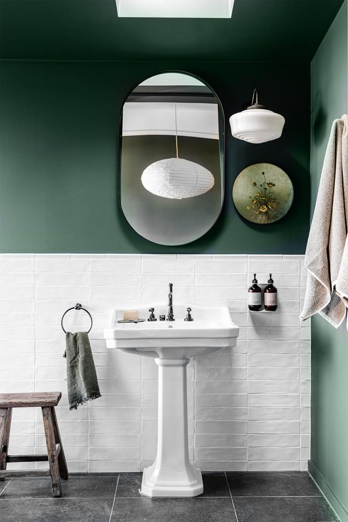Although bathroom of this [Federation home with a Japanese-inspired extension](https://www.homestolove.com.au/japanese-inspired-federation-home-renovation-23823|target="_blank") blends classic, Japanese and classic aesthetics, it achieves the perfect balance effortlessly. A pedestal sink adds a touch of the traditional, while the curved mirror contemporises the space.