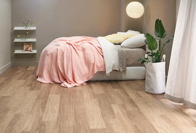 Timber-look flooring from the Choices Flooring [Abode Hybrid collection](https://www.choicesflooring.com.au/floors/rigid-hybrid-flooring-range|target="_blank"|rel="nofollow") creates warmth in this bedroom. This is the 'Elevate' style in colour 'Spotted Gum'.
