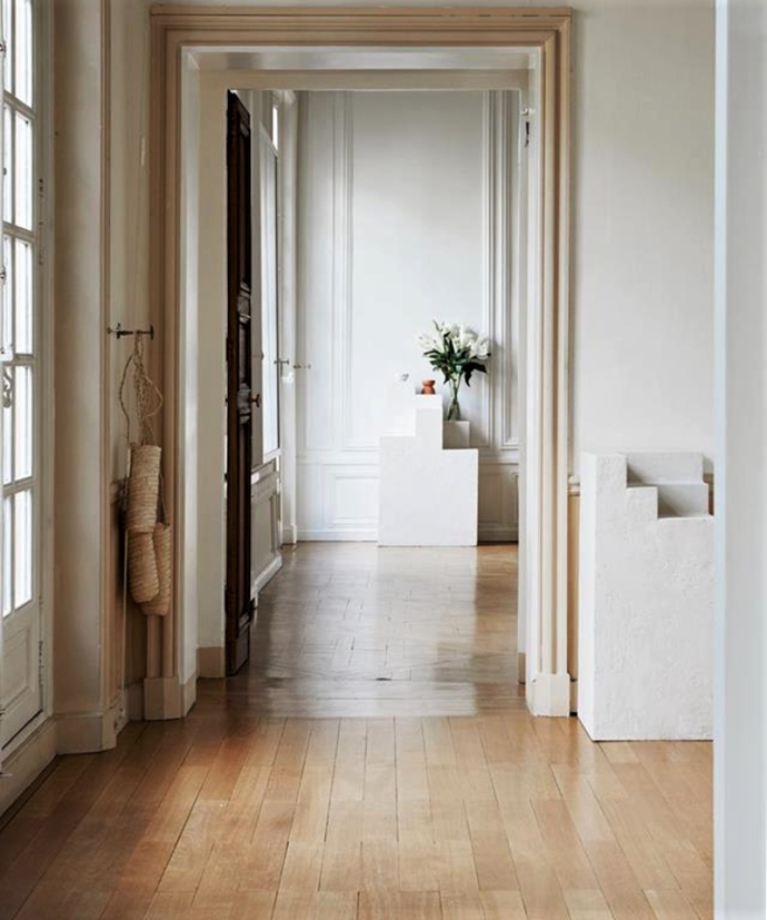 Timber floors introduce warmth from the ground up in this Paris apartment.