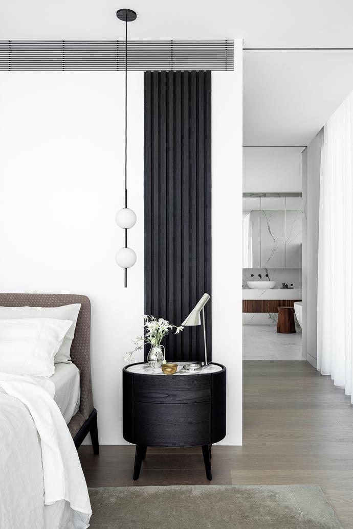 Texture rules in the main bedroom. 'Kelly' king bed with woven Nabuk headboard, 'Kelly' night table and 'Frame' rug, all from Poliform. Nightworks 'Code' pendant light from Workshopped. [Louis Poulsen 'AJ' table light](https://www.finnishdesignshop.com/lighting-table-lamps-table-lamps-table-lamp-black-p-7976.html?region=au|target="_blank"|rel="nofollow") from Cult. [Linen from In Bed](https://www.theiconic.com.au/linen-duvet-cover-1299308.html|target="_blank"|rel="nofollow"). Batten timber screen in Ravenwood by Screenwood.