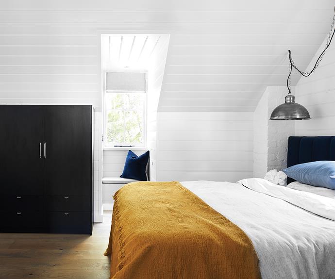 **MAIN BEDROOM** Mafi floorboards from [Woodos](https://woodos.com.au/|target="_blank"|rel="nofollow"), used throughout the sleeping quarters and ensuite, make the space feel more expansive. In contrast, all the new joinery is [Polytec](https://www.polytec.com.au/|target="_blank"|rel="nofollow") Woodmatt in Black. Pendant light, [Emac & Lawton](https://www.emac-lawton.com.au/|target="_blank"|rel="nofollow"). Bed linen, [In The Sac](https://inthesac.com.au/|target="_blank"|rel="nofollow").