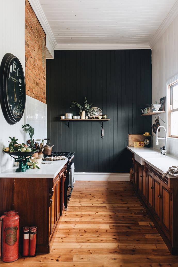 Adding a dark feature wall can give your kitchen a sultry and moody look.