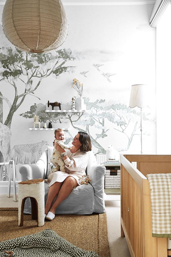 Katie and Charlie, now seven months, sit on a Maxime occasional chair from Coco Republic. Safari Montage wallpaper designed by Katie and made by Pickawall.