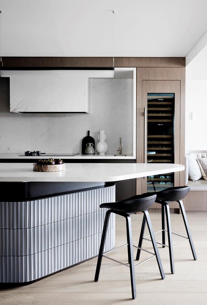A wine cabinet is the ultimate focal point of this entertainer's kitchen in [a luxurious apartment](https://www.homestolove.com.au/luxurious-apartment-sydney-harbour-22224|target="_blank") overlooking Sydney Harbour.  