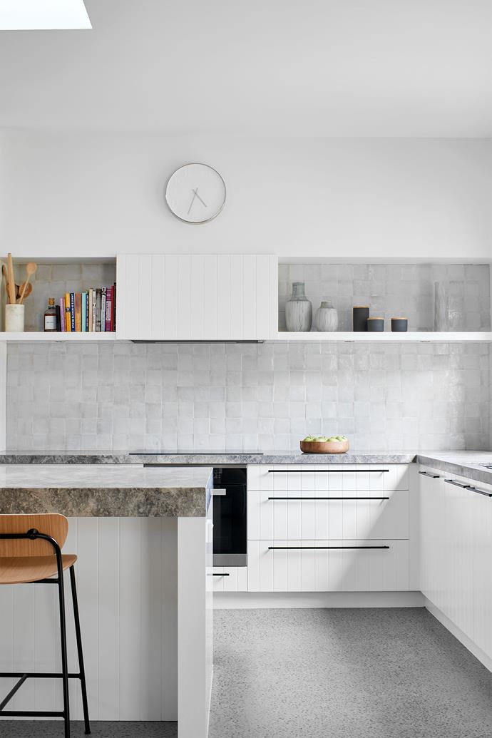 The monochrome kitchen palette is heightened with textural handmade Moroccan tiles and honed stone benchtops in 'Grey Aether' marble from G-LUX, joinery in Dulux 'Natural White' with 'Slimline' handles from MadeMeasure, and a Teknobili 'Oz T7' curved gooseneck sink mixer from Reece. Stools, client's existing. Splashback in Zellige 'Seafoam' glazed clay tiles from Eco Outdoor.