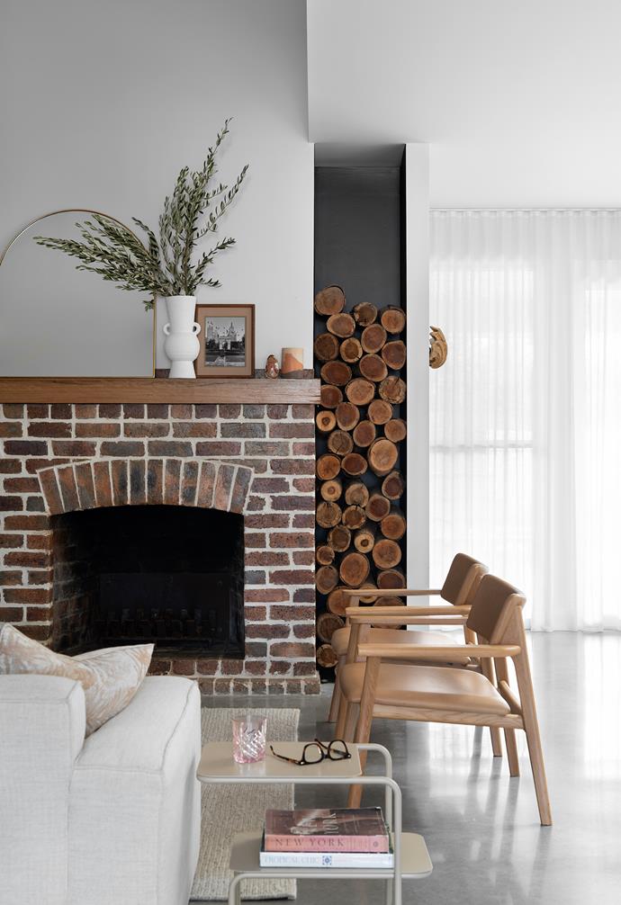 The [fireplace](https://www.homestolove.com.au/cosy-fireplaces-that-will-warm-your-heart-3475|target="_blank") and archway are made from bricks original to the cottage, with the arch redesigned as a bookshelf. Sofa, leather armchairs, coffee table, side table, rug and decorative items, [Kira & Kira](https://kiraandkira.com.au/|target="_blank"|rel="nofollow").