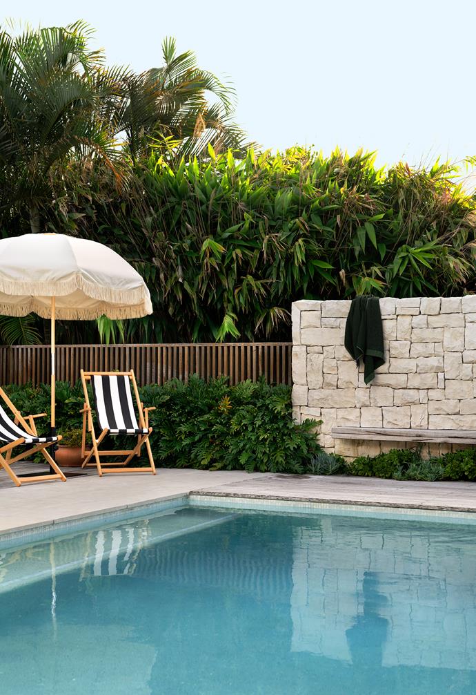 The pool wall is made of Newport Random Ashlar natural stone and the pavers are Garonne limestone, both from [Eco Outdoor](https://www.ecooutdoor.com.au/|target="_blank"|rel="nofollow"). Blackbutt timber and white paling fences, Davey Constructions. Chairs and umbrella, [Basil Bangs](https://basilbangs.com/|target="_blank"|rel="nofollow").