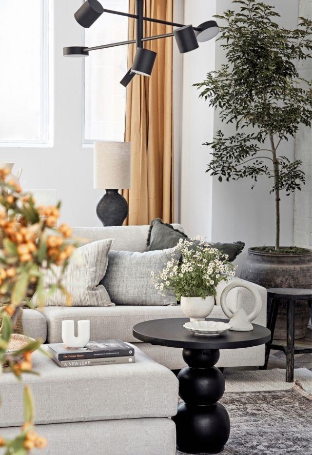 Here, the Onyx 6-light pendant from Beacon Lighting shines a light on focal points in the living space. A table lamp from Freedom adds to the ambience. Also pictured is the Joan side table by McMullin & Co, a Jardan vessel, Black Blaze's Femme. Hoop vase and the Rinka plate from DEA Store.