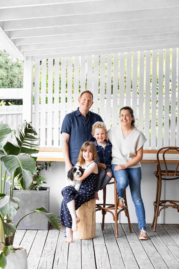 Matt and Hannah enjoy a moment on their reclaimed timber verandah with son Joe, daughter Stevie and their adorable two-year-old dog, Teddy.