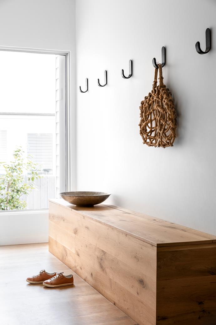 A [minimalist approach](https://www.homestolove.com.au/minimalist-homes-6769|target="_blank") has been taken in the sun-filled mudroom, which is furnished with an American oak storage bench, Robert Gordon ceramics and [Normann Copenhagen](https://www.mrandmrsdesigner.com.au/collections/normann-copenhagen-australia|target="_blank"|rel="nofollow") hooks. It's a decidedly calming [entry point](https://www.homestolove.com.au/entryway-ideas-that-make-a-good-first-impression-5353|target="_blank").