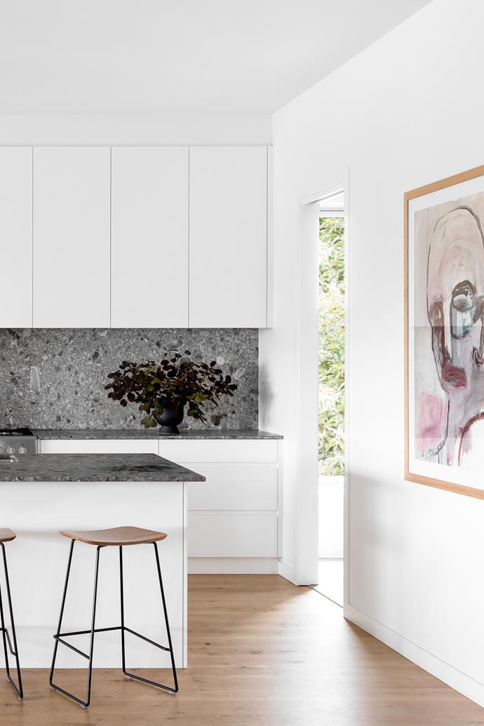 A limestone benchtop and splashback from CDK Stone appears in the kitchen, along with American oak flooring from Eco Timber and cabinetry by DPR Joinery. The stools are from Huset and the artwork is 'State of Things' by [Brendan Kelly](https://www.brendankellyart.com/|target="_blank"|rel="nofollow").