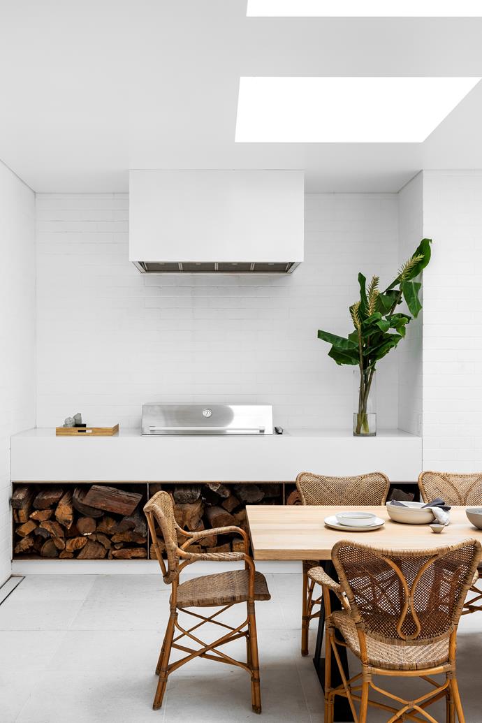 The [covered barbecue area](https://www.homestolove.com.au/outdoor-kitchen-ideas-6227|target="_blank") at the back of the house is a space for all seasons. Luna dining table and Piana cane dining chairs, MCM House.