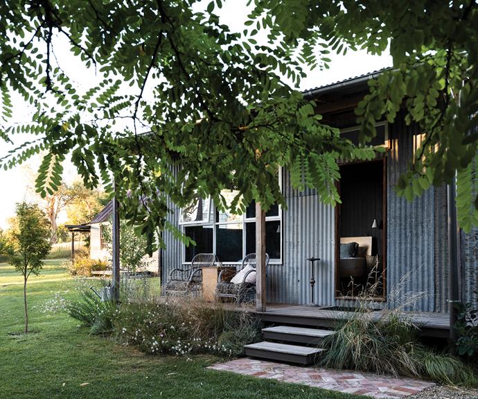 The [verandah](https://www.homestolove.com.au/country-verandahs-13365|target="_blank") is the best spot for watching passing kangaroos, wallabies, cattle, deer, sheep and native birds. In the garden, Yvette and Ollie planted butterfly bush and poa grass to create a native cottage garden feel.