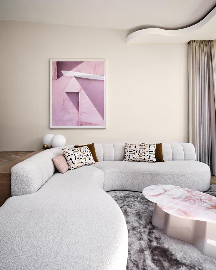 A custom cream boucle banquette by Decus Interiors sits atop a custom Tencel silk rug with material from [Whitecliff Imports](https://www.whitecliffe.com.au/|target="_blank"|rel="nofollow"). The custom cushions are made from Lelievre 'Regate' fabric in Flamant from South Pacific Fabrics, Kvadrat Maharam 'Byram' fabric, and Nya Nordiska 'Raja' fabric in Powder from Ascraft. The 'Peach Wall' artwork is by [George Byrne](https://www.georgebyrne.com/|target="_blank"|rel="nofollow") and the Copycat table lamp is by [Michael Anastassiades](https://michaelanastassiades.com/|target="_blank"|rel="nofollow").