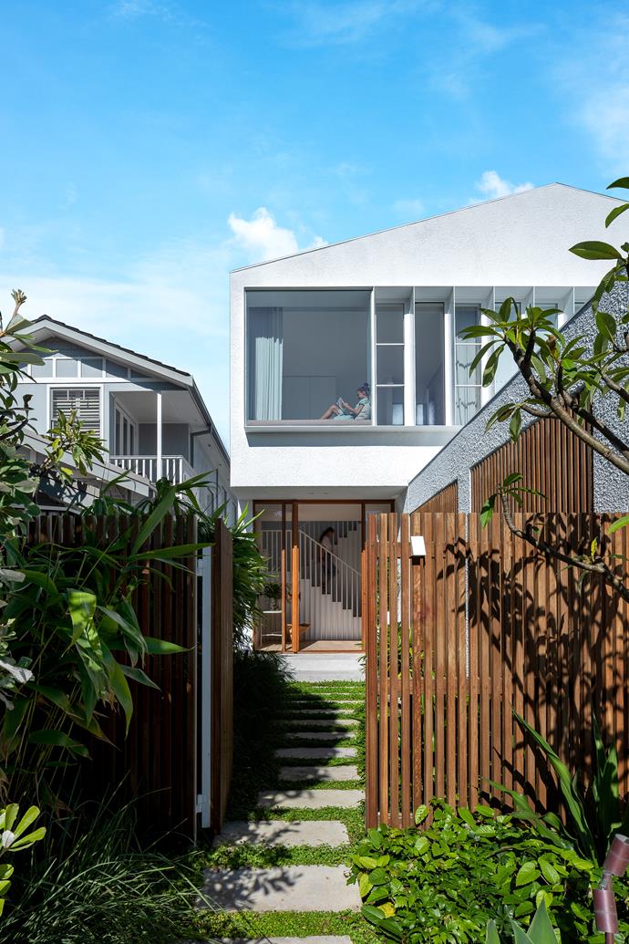 Twelve-year-old Leni laps up the sunshine in her upstairs bedroom. Render in Dulux Vivid White lends the exterior a fresh, clean look. The fence is blackbutt battens with a Cutek natural oil finish.