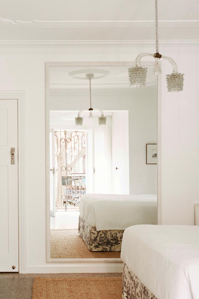 So dreamy: The peaceful main bedroom is a true retreat. Toile gives the AP Design House bed a [classic French feel](https://www.homestolove.com.au/french-provincial-style-10-key-elements-6741|target="_blank") as does the embroidered Parisian bedspread, which was sourced by Alexandra from a Parisian market. A [jute rug](https://www.homestolove.com.au/sisal-flooring-design-ideas-21672|target="_blank") grounds the space.