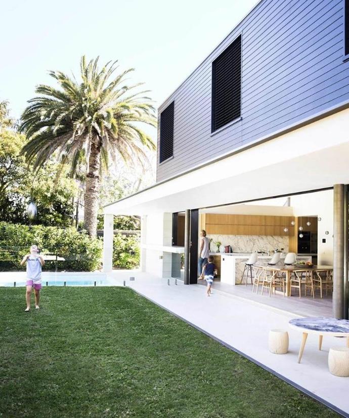 The open-plan living area of this [revamped Federation home](https://www.homestolove.com.au/gallery-prues-hidden-federation-gem-2581|target="_blank") looks out over a verdant stretch of lawn.