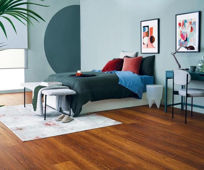 A bold colour palette of teal, blue and rich red is complemented by the warm hues of ['Abode Coastal' hybrid flooring](https://www.choicesflooring.com.au/floors/rigid-flooring-range/Abode-Coastal/postid=14363/swatch=Campari|target="_blank"|rel="nofollow") in colour 'Byron Bay Spotted Gum'.