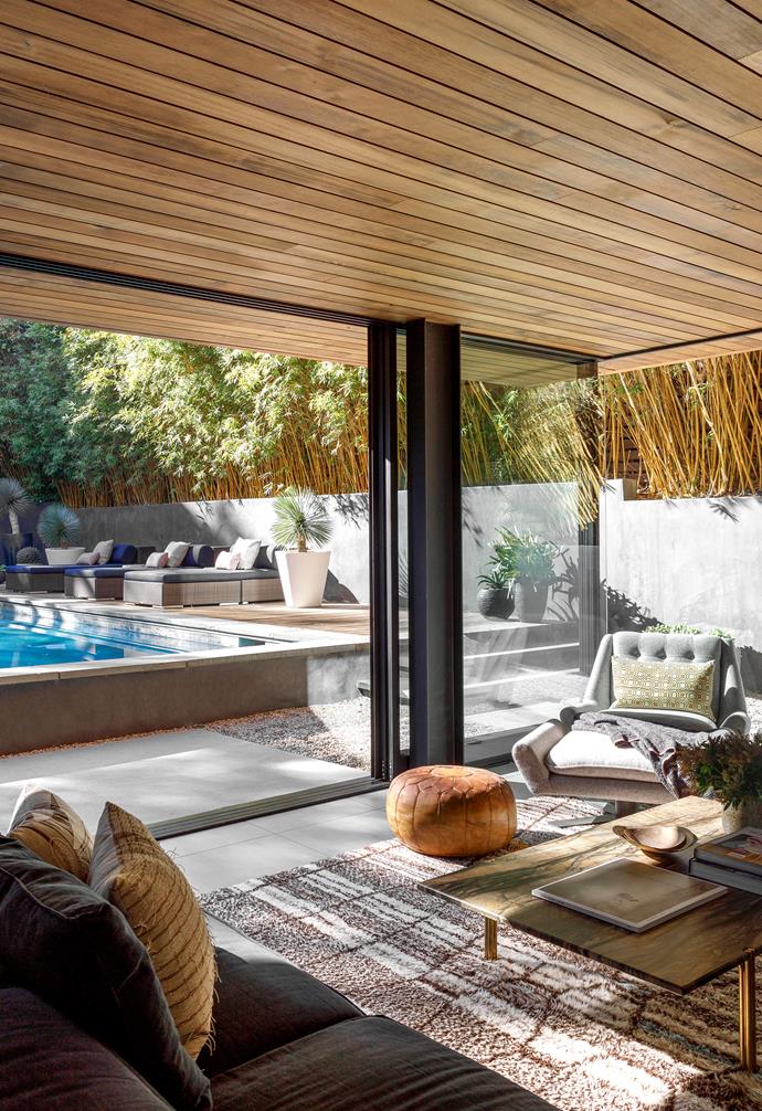 **FAMILY ROOM** New sliding doors have aligned this relaxed space with the pool. Interior designer Vanessa Alexander designed the deep blue sofa and wall-hung bronze shelving. Rug, [Mehraban](https://mehraban.com/|target="_blank"|rel="nofollow").