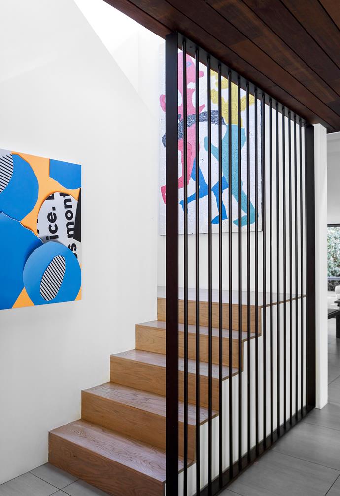 **STAIRCASE** Artworks by [Ramsey Dau](https://ramseydau.com/|target="_blank"|rel="nofollow") (at left) and Ed Moses add interest to the trip up to the new main bedroom, which has all the amenities.