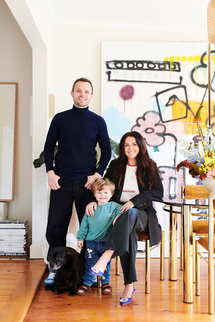 Steve and Bobby Clark with their son, Jimmy, and Scout the Staffordshire terrier. Their dining room is home to a large untitled mixed media artwork on concrete board created by Steve. The vintage dining table and chairs, from Curated Spaces, were acquired through a 'creative swap'.