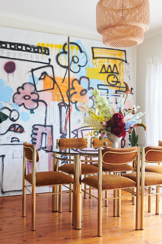 The mixed media artwork by Steve Clark and vintage dining table and chairs from [Curated Spaces](https://www.curatedspaces.com.au/|target="_blank"|rel="nofollow") make for a dramatic and playful dining room. The flowers and vase are by [Honesty Flora](https://www.honestyflora.com/|target="_blank"|rel="nofollow").