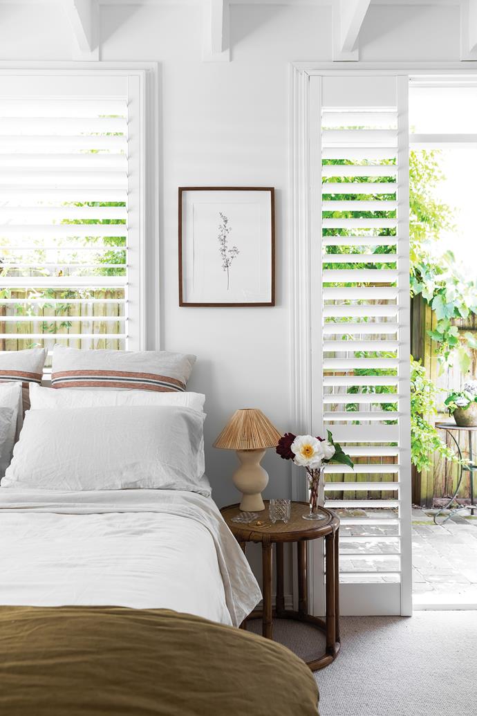 **MAIN BEDROOM** Plantation shutters from [Marlow & Finch](https://www.marlowandfinch.com.au/|target="_blank"|rel="nofollow") allow for plenty of natural light and ventilation. Bedding, [In Bed](https://inbedstore.com/|target="_blank"|rel="nofollow"). Rattan side table, [Naturally Cane](https://www.naturallycane.com.au/|target="_blank"|rel="nofollow"). Lamp by [Marianne Roussety](https://marianneroussety.com/|target="_blank"|rel="nofollow"). Crystal vase and dish, Heidi's family heirlooms. Artwork, vintage.