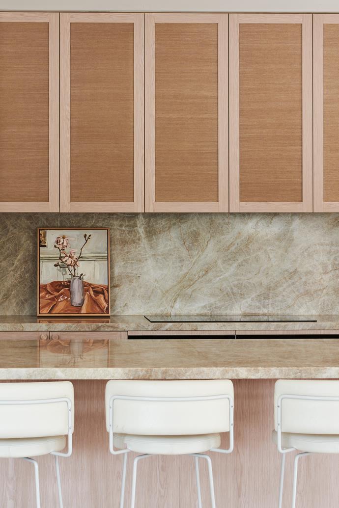 Balancing act: "Sometimes design is more about aesthetics. But in this kitchen, practicality and aesthetics were both equally important. Ticking all the boxes was challenging, but the kitchen is both stunning and practical. And we used such beautiful natural materials," says Georgia. The cabinets are by [New Age Veneers](https://www.newageveneers.com.au/|target="_blank"|rel="nofollow"); the wallpaper is by [Style Rev](https://www.stylerevolutionary.com/|target="_blank"|rel="nofollow"). The quartzite bench is by [Corsi & Nicolai](https://www.cnanaturalstone.com/|target="_blank"|rel="nofollow"), while the Diiva stools are from [Grazia & Co](https://www.graziaandco.com.au/|target="_blank"|rel="nofollow"). The artwork is by [Emma Leonard](https://www.emmaleonardart.com/|target="_blank"|rel="nofollow").