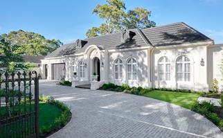 Hamptons style white home exterior with arched windows