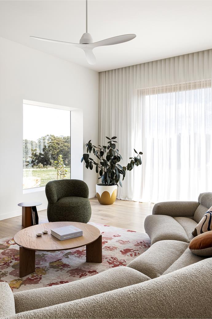 Soft curves and textured materials make this living room a calm oasis with nods to the rural surrounds. Native bushland inspires the colour palette, as seen in Jardan's 'Valley' sofa and 'Joy' armchair. The Newstead rug from [Designer Rugs](https://www.designerrugs.com.au/|target="_blank"|rel="nofollow"), made from Tibetan wool, hemp and bamboo silk, adds warm colour while the asymmetrical pattern creates visual interest.