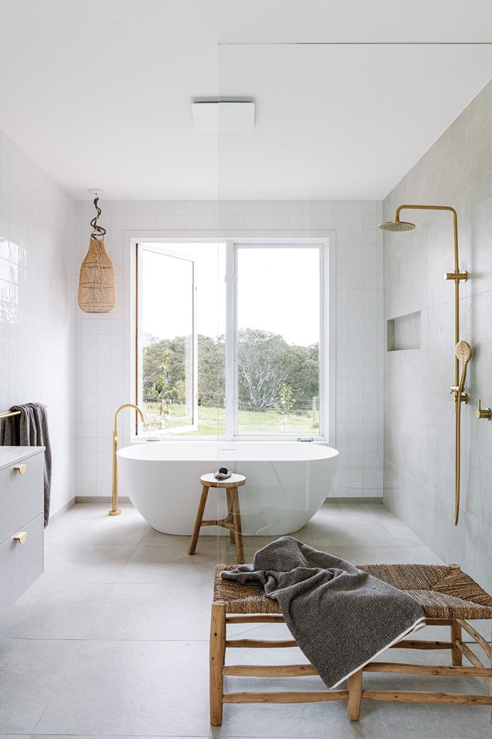 Starting from scratch meant that the owners of this [sustainable country home in Winchelsea](https://www.homestolove.com.au/sustainable-country-build-winchelsea-24051|target="_blank") could create a larger-than-average ensuite. A freestanding bathtub is position overlooking the rugged surrounds, which are matched beautifully by the bras hardware and tapware.