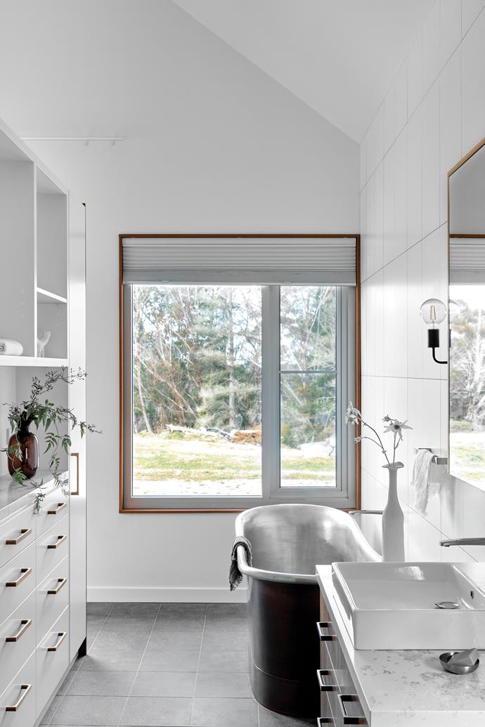 The bathroom of this [sustainably-built home in Blackheath](https://www.homestolove.com.au/contemporary-low-tox-build-blackheath-nsw-24261|target="_blank") is large enough to enjoy storage of just about every kind - from linen cupboards to open shelving and drawers.