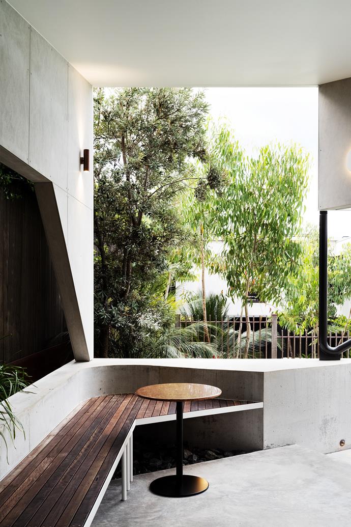 The home's original architect, David Boyle, was re-engaged to give the house a facelift and design the striking cabana. Iron bark benchseat, custom terrazzo table. Coast banksia (*Banksia integrifolia*) and scribbly gum (*Eucalyptus haemastoma*) help define the boundary.