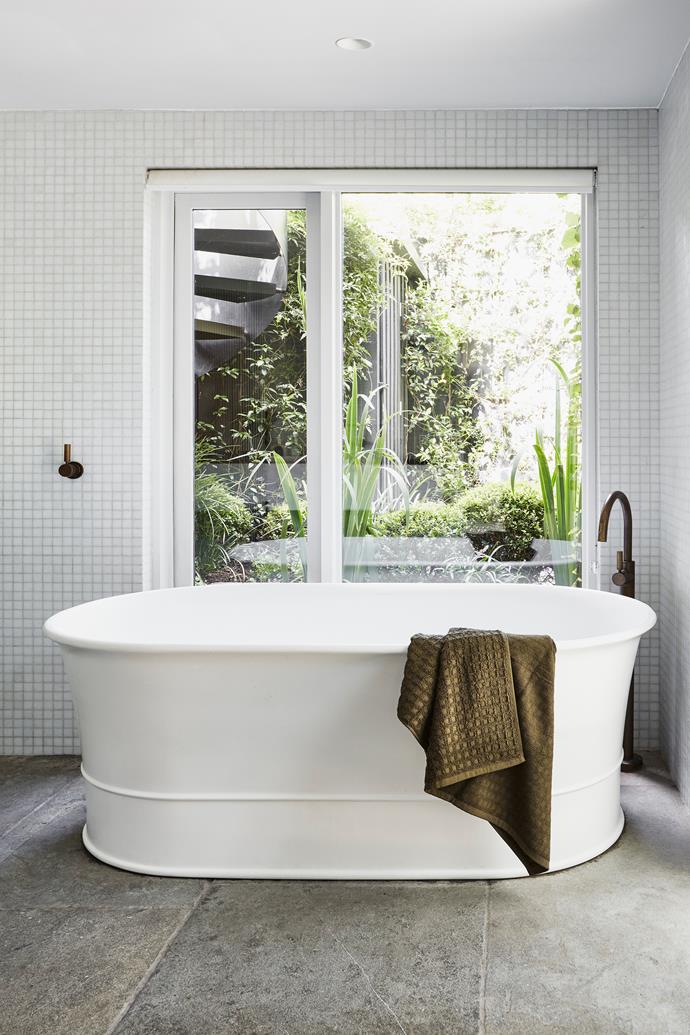 A freestanding bathtub takes pride of place in the main bathroom of TV presenter [Edwina Bartholomew's former home in Sydney](https://www.homestolove.com.au/edwina-bartholomew-dulwich-hill-home-24489|target="_blank"). A leafy green outlook offers views into the internal courtyard beyond.