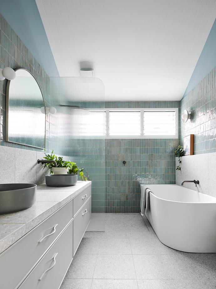 The blue-hued bathroom of food stylist, recipe creator and editor [Emma Knowles](https://www.homestolove.com.au/renovated-semi-detached-heritage-home-sydney-24504|target="_blank") is about as calming as they come. Terrazzo tiles line the vanity, floor and in-built shelf, while a freestanding bath and shower behind rippled glass beckon.