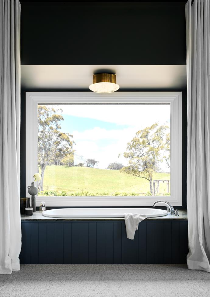 This stunning [modern country homestead](https://www.homestolove.com.au/arent-and-pyke-modern-country-house-design-lake-view-24549|target="_blank"), designed by Arent&Pyke, offers a new level of designer luxury - and the bathroom is no exception. In the main ensuite, a large bathtub is set into a bay window overlooking gorgeous views of the NSW countryside.