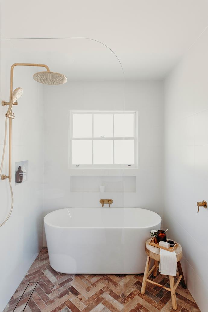 In this [romantic, reimagined cottage](https://www.homestolove.com.au/river-haus-morpeth-24945|target="_blank"), terracotta tiles give this walk-in shower a warm and cosy feel, while the luxurious gold finishes add a touch of elegance and sophistication. 
