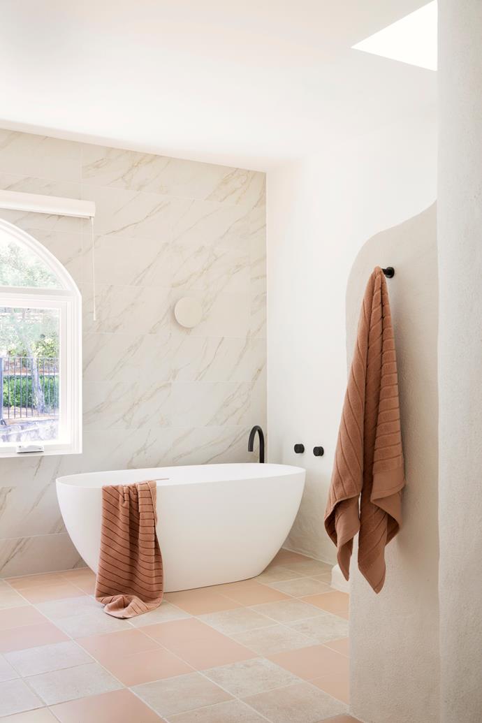 Cremorne wall tiles, Seaforth floor tiles in Beige and Balmoral floor tiles in Dusty Blush, all TileCloud. Kado Lussi freestanding bath and Milli Pure wall hooks, Reece. Pirouette window shades, Luxaflex.