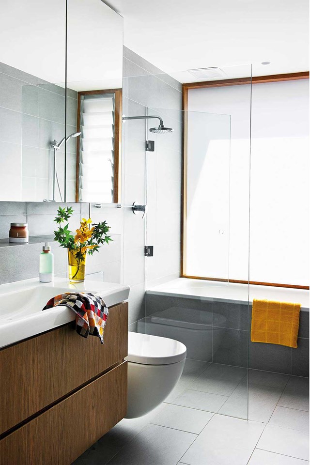 Many bathroom shower designs are led by access to plumbing. With all your fixtures lined up along one wall, it becomes more straightforward. Space is also optimised without corners to be filled. Here, fittings graduate from narrow to wide towards to back wall, with the bath spanning the entire width of the wall furthest away.