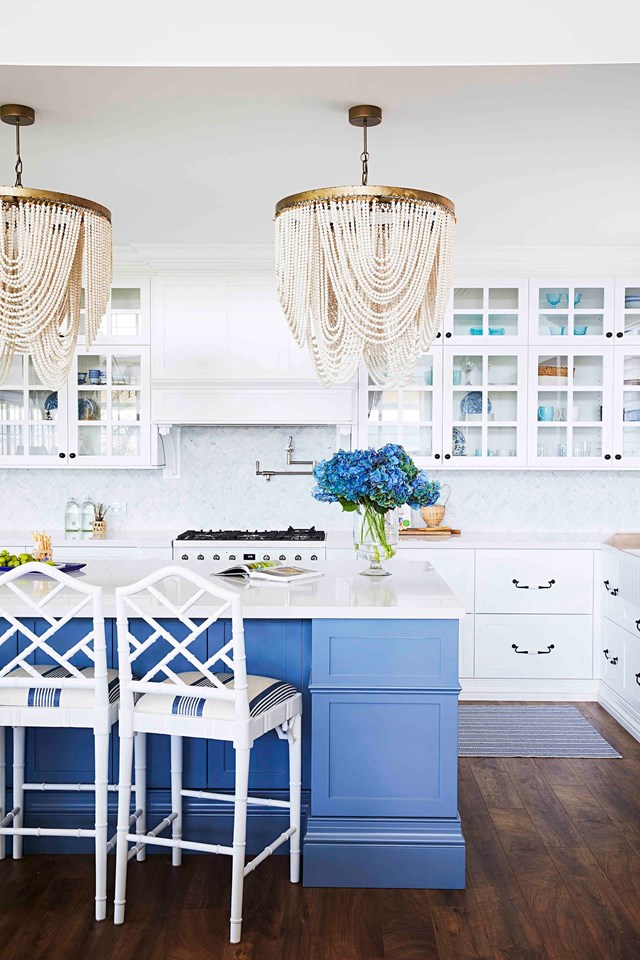For this take on the two-toned trend, homeowner Natalee anchored a white-on-white kitchen with a sky-blue island making this palatial [Hamptons-inspired farmhouse](https://www.homestolove.com.au/hamptons-farmhouse-22788|target="_blank") feel light and airy. 

*Photographer: Cath Muscat | Story: Home Beautiful*