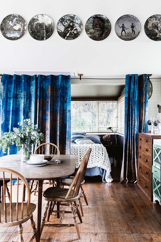 [Styling a bedsit](https://www.homestolove.com.au/styling-a-small-bedsit-3841|target="_blank") has never looked so good. This [modern bush home](https://www.homestolove.com.au/modern-australian-bush-home-12157|target="_blank") has transformed its open plan into a distinctive feature. A blue curtain creates zones without depriving the dining room and kitchen of natural light.