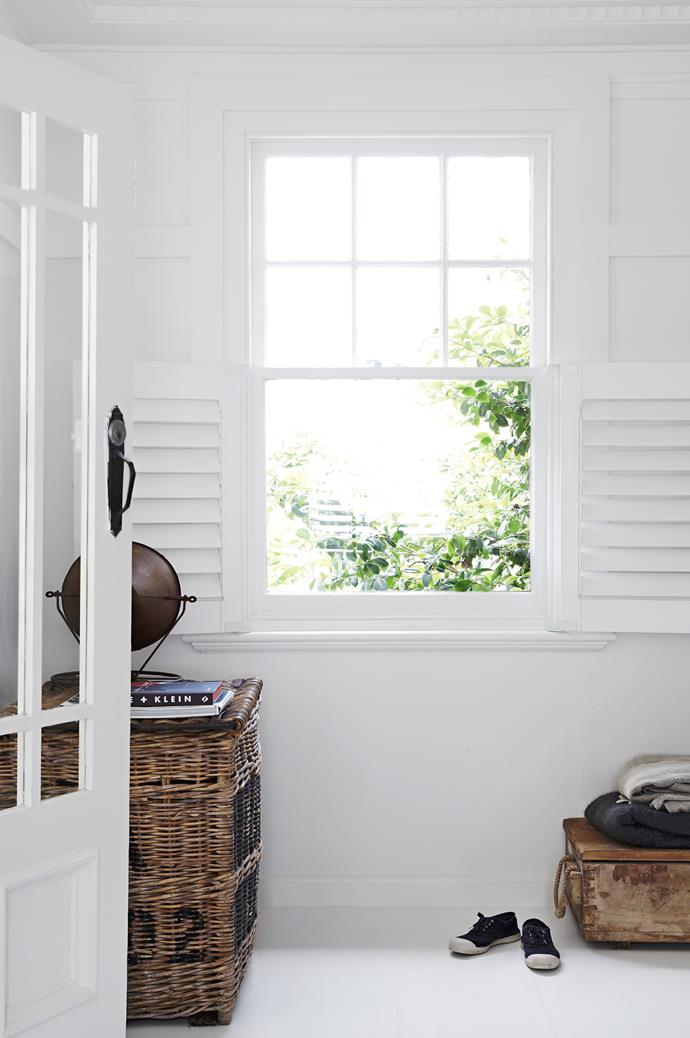In the sitting room, a pair of plantation shutters can be flung open to let in natural sunlight while an old ammunition box has been re-purposed as storage for extra throw rugs.