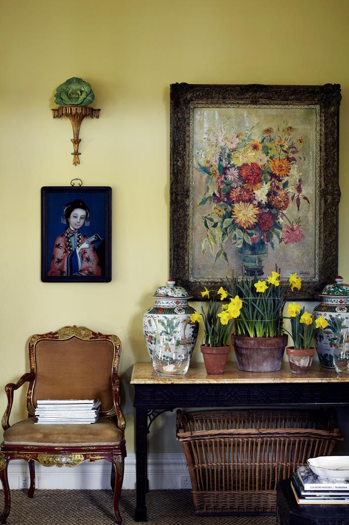 Daffodils in terracotta pots adorn a console table in the living room.