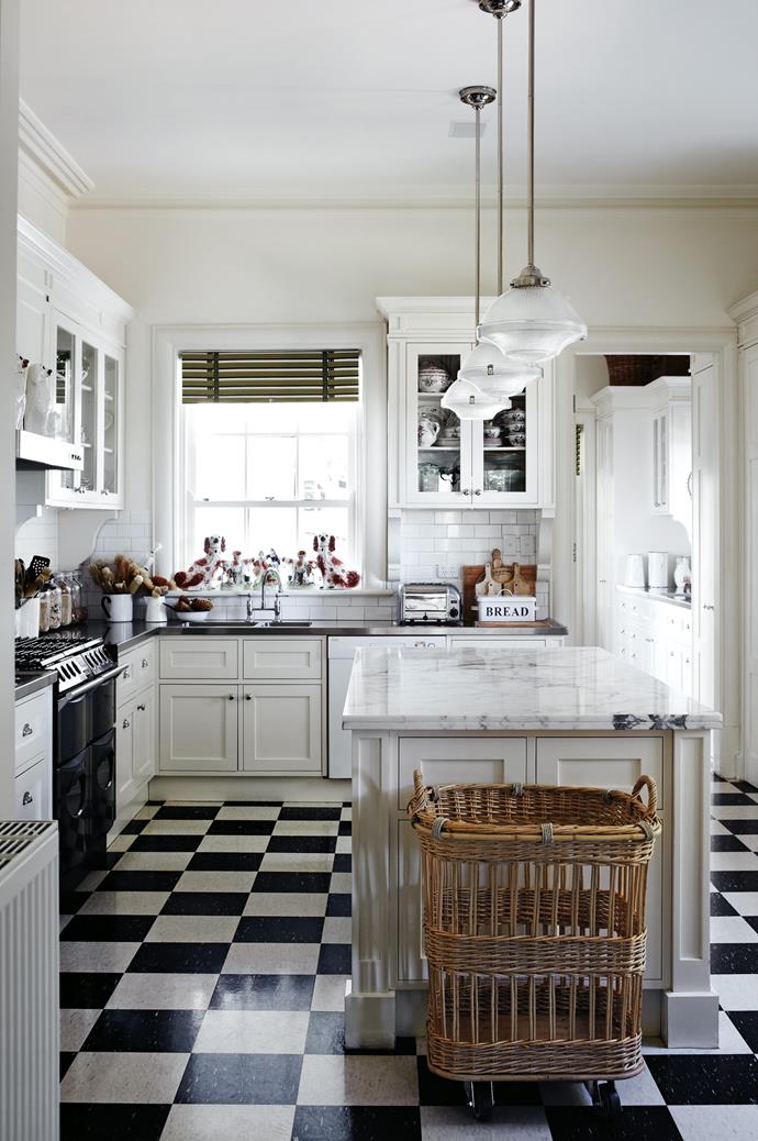 The [classic country kitchen](https://www.homestolove.com.au/country-kitchen-design-ideas-13266|target="_blank") with shaker cabinets, marble island bench and chequerboard flooring.