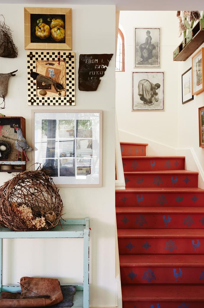The unique red stairs have been stencilled using Annie's favourite French blue. Two Van Gogh prints hang above the stairs.